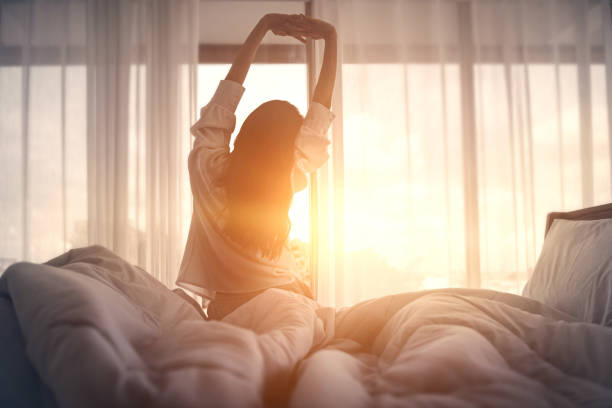 happy woman stretching in bed after waking up happy young girl greets good day, भोरे उठला के बाद एह मंत्रन के जप करीं, दिन नीमन होई, सुख समृद्धि बढ़ी, Faith, Mantra, religious deeds, worship,
