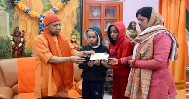 CM Yogi Adityanath handing financial aid cheque to family of journalist Vivek Asthana in Gorakhpur